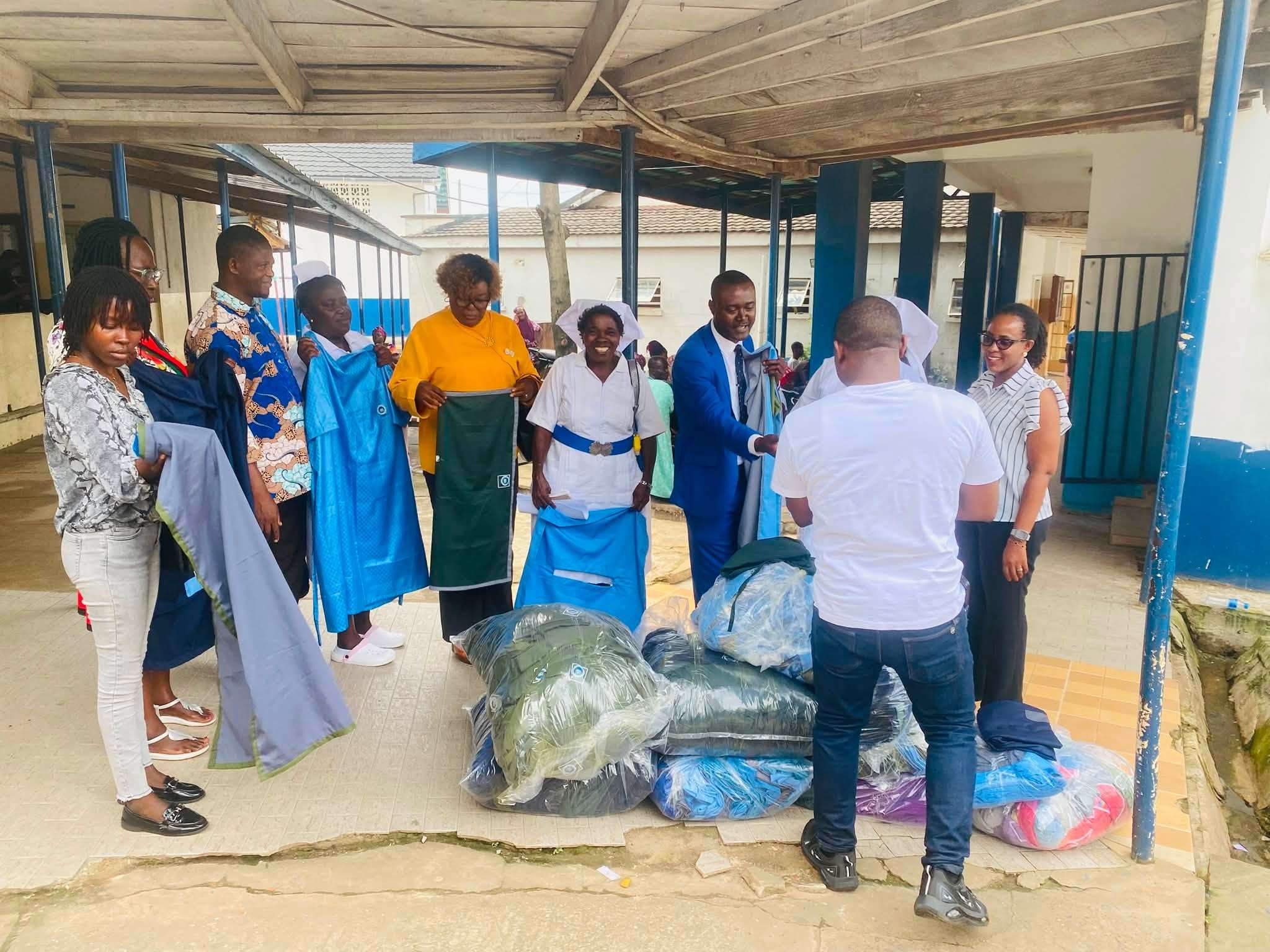 Theatre linen being handed over and unfolded for inspection at a hospital, during the handover for the National IPC Programme